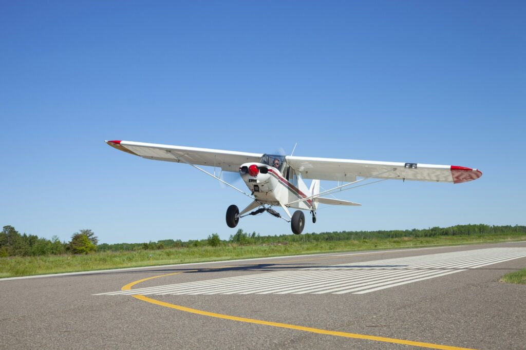 Small airplane takes off from a municipal airport on a sunny afternoon